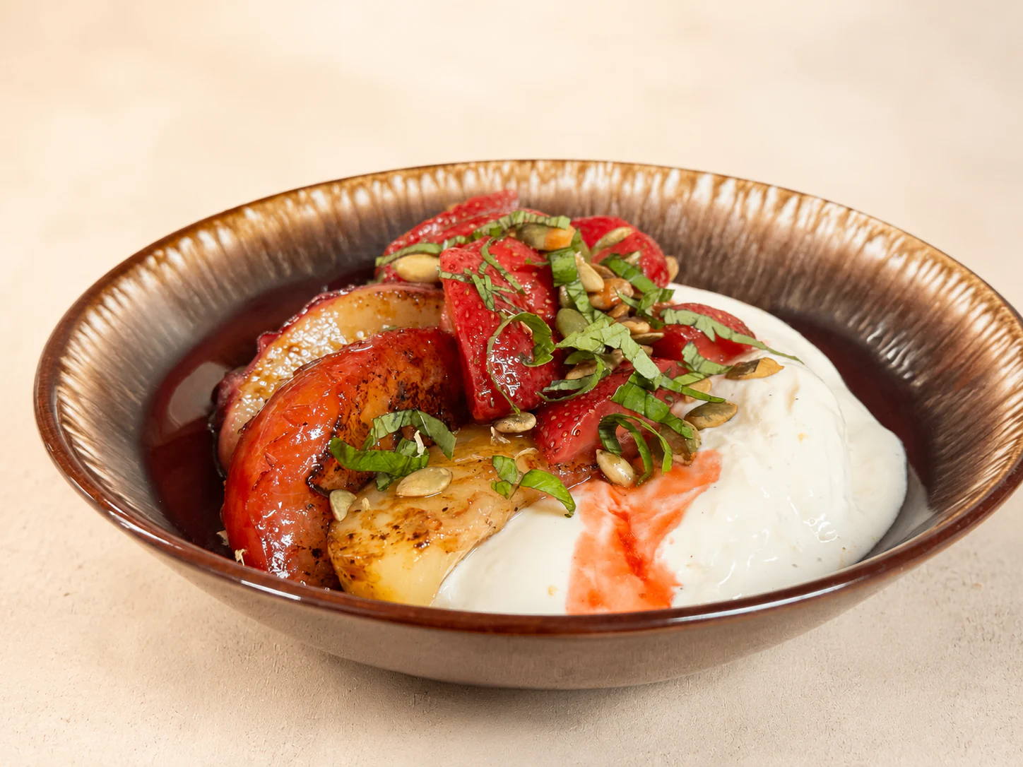 Seasonal strawberry and stone-fruit dessert with cream, herbs, and toasted seeds